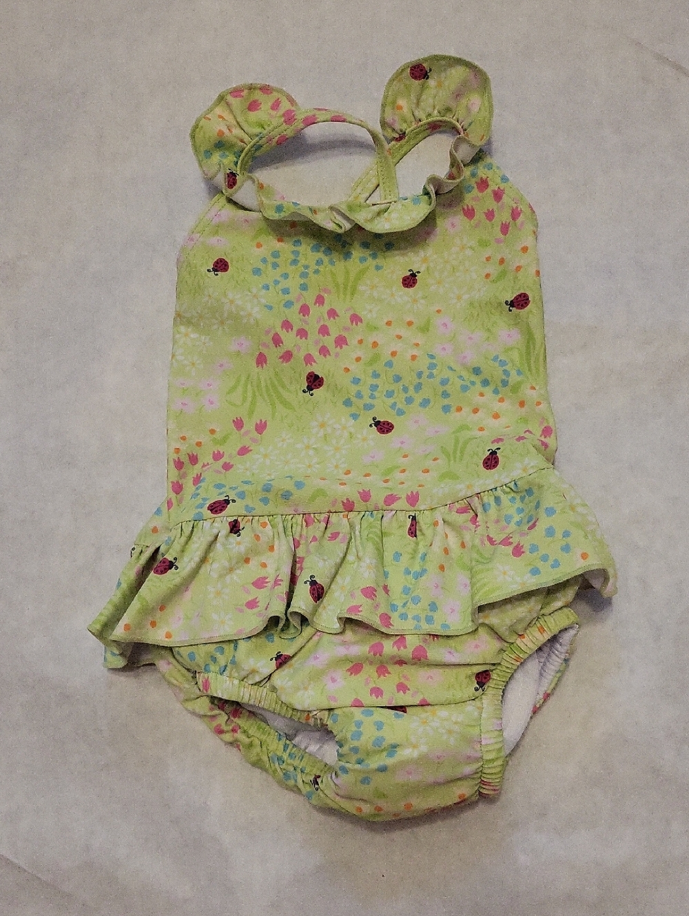 Mint green ruffled one-piece swimsuit with ladybug print